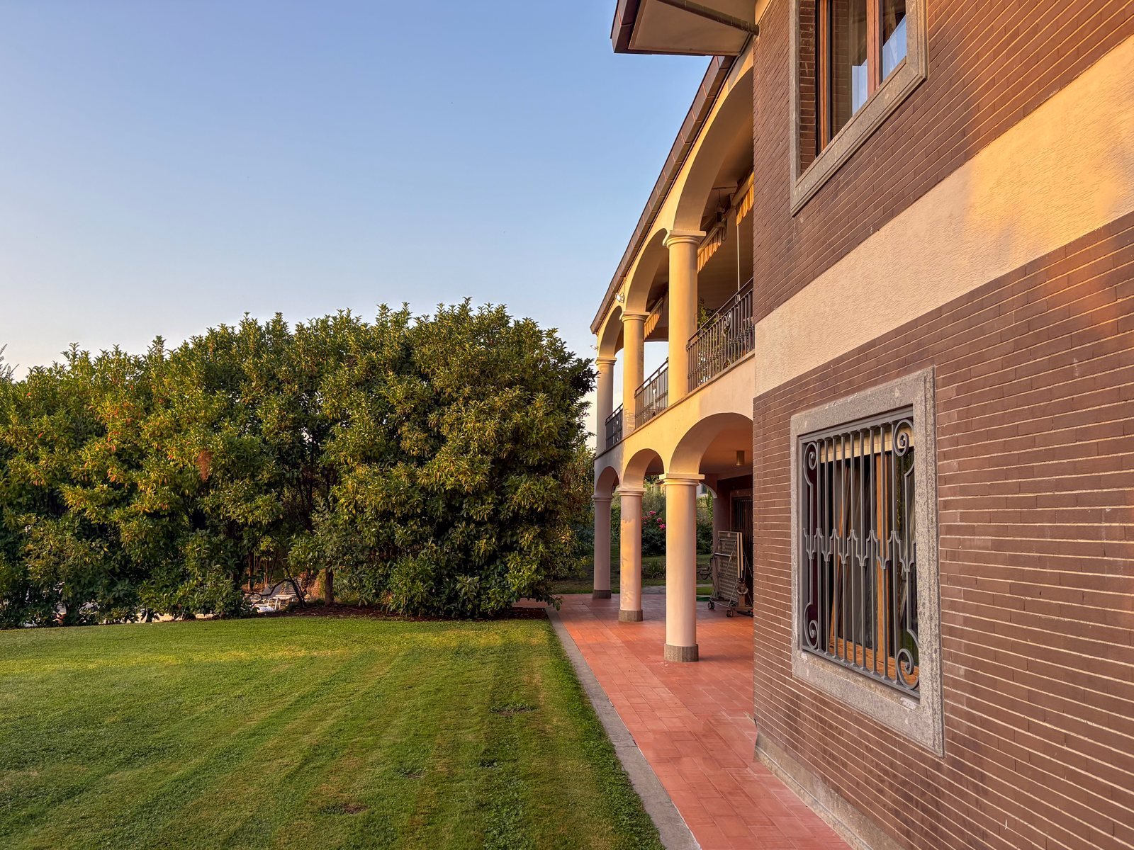 Villa Sofia at golden hour: the arched loggia and the lawn