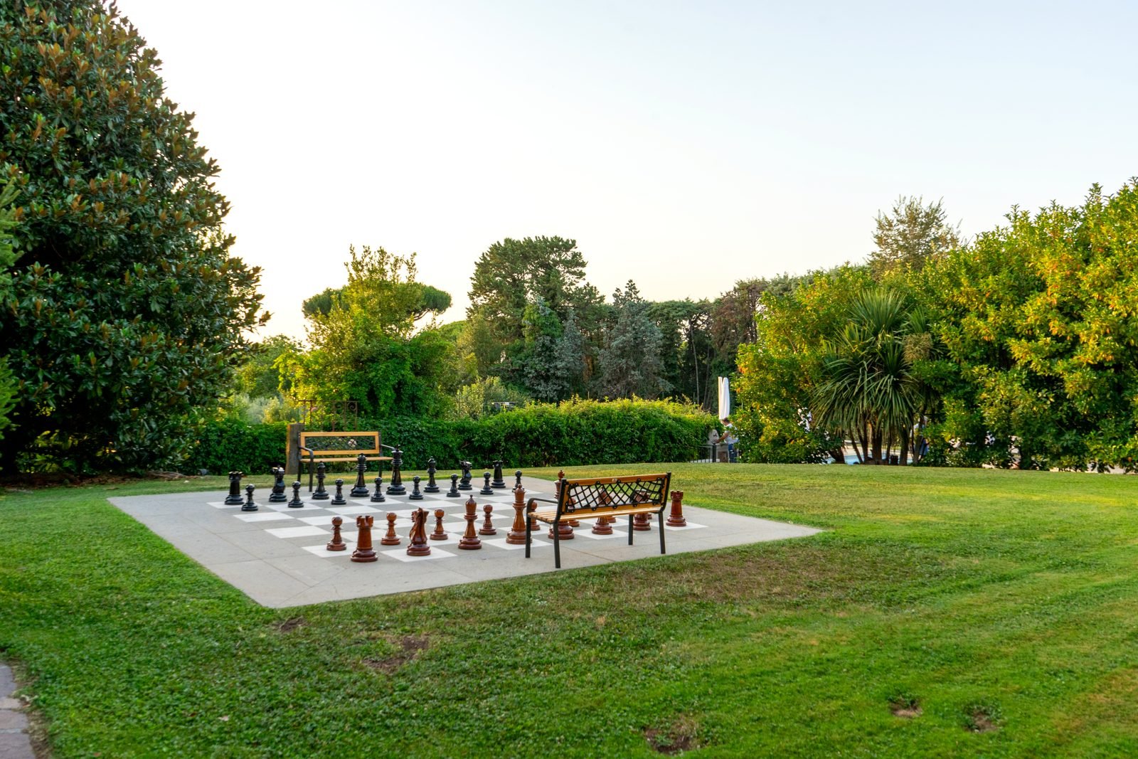 Giant chess on the lawn, the pool beyond