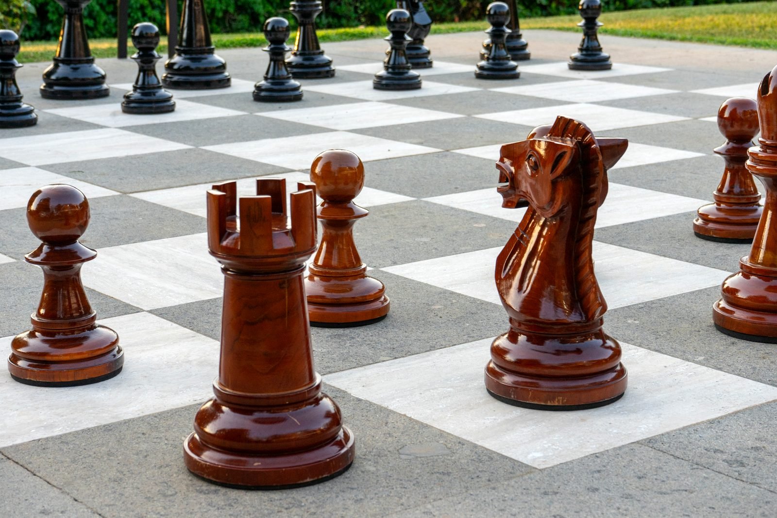 The chess pieces up close in the evening light