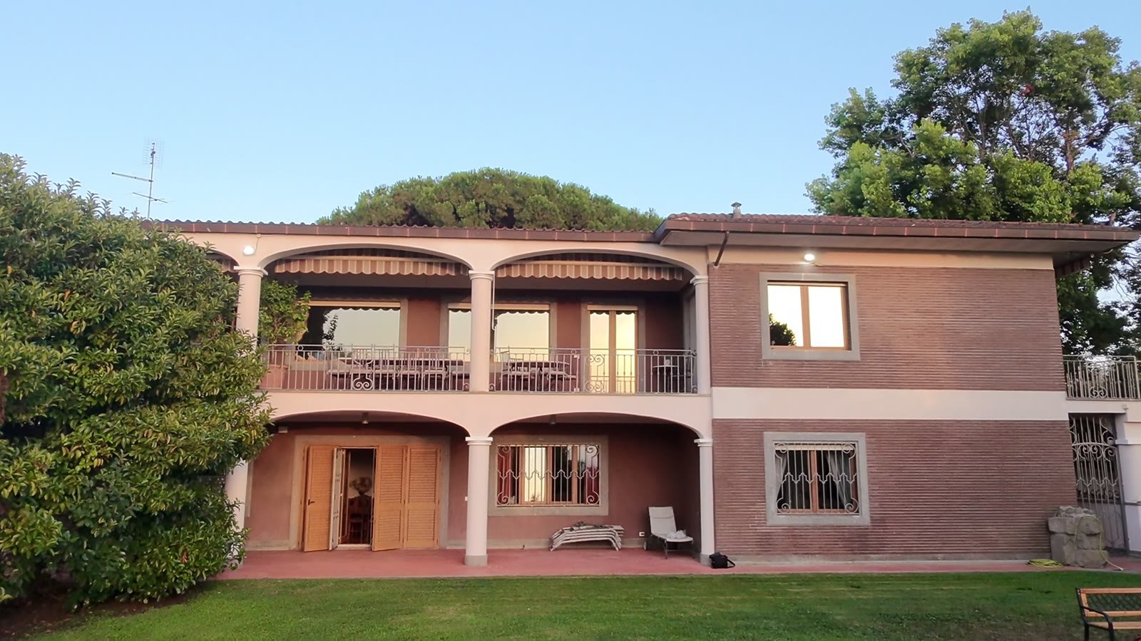 The villa and its terraces under the umbrella pines
