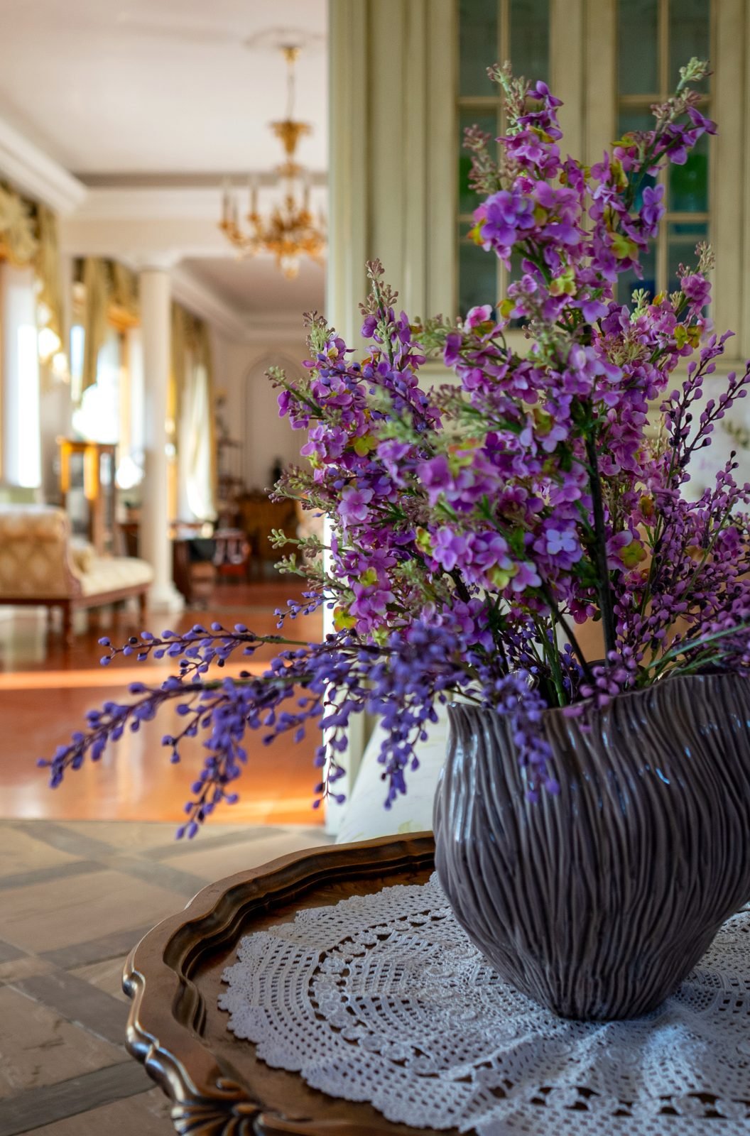 Flowers on a side table, the salon beyond