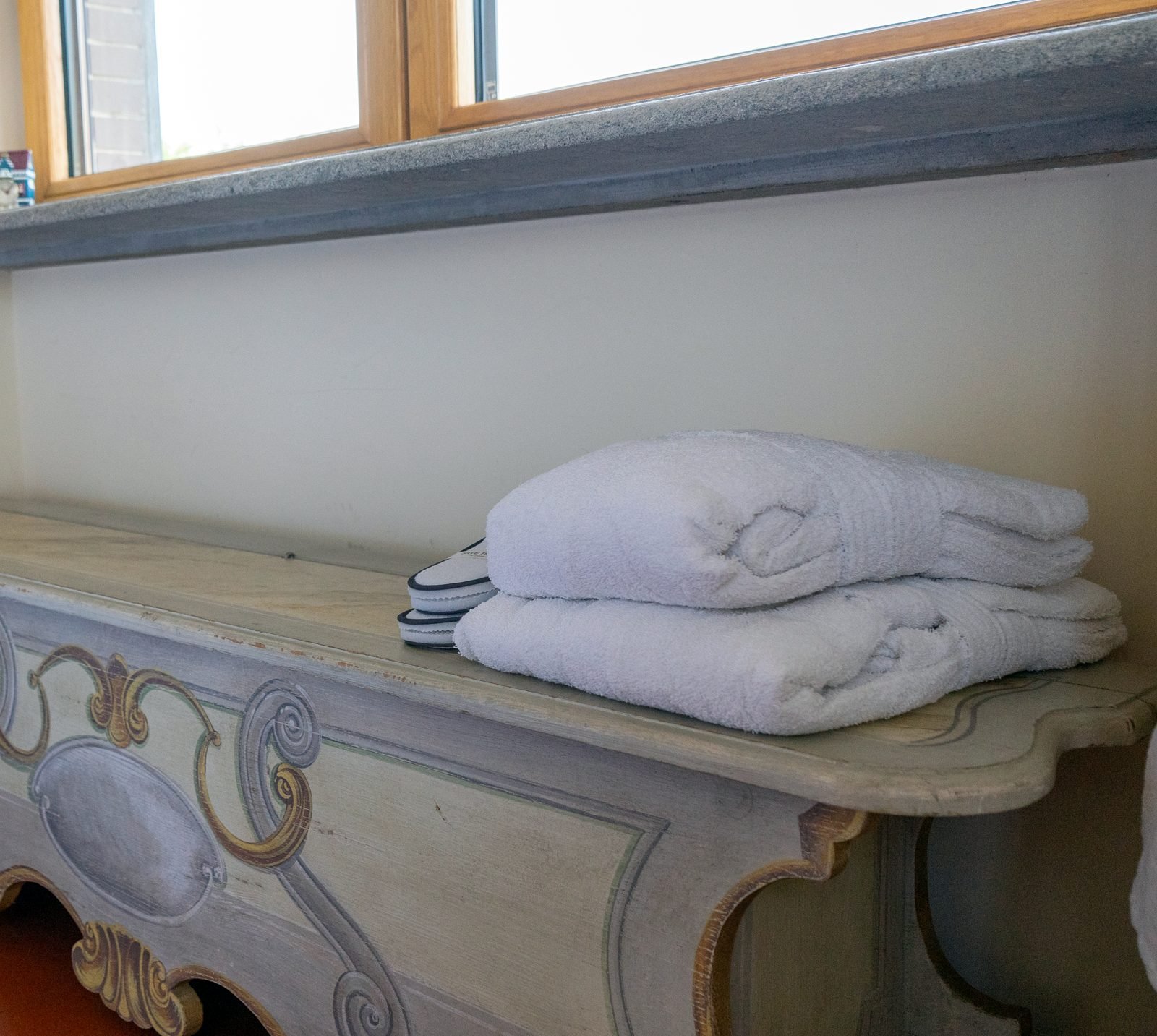 Painted bench with bathrobes and slippers