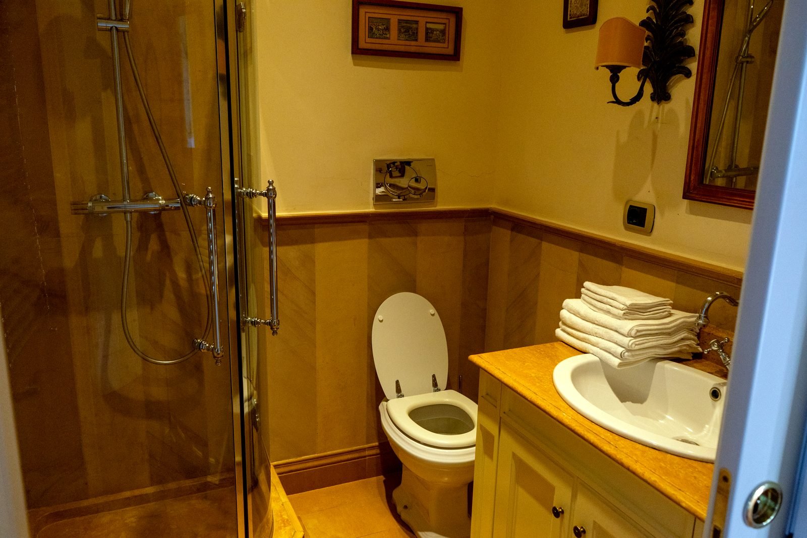 Bathroom with walk-in shower and marble surfaces